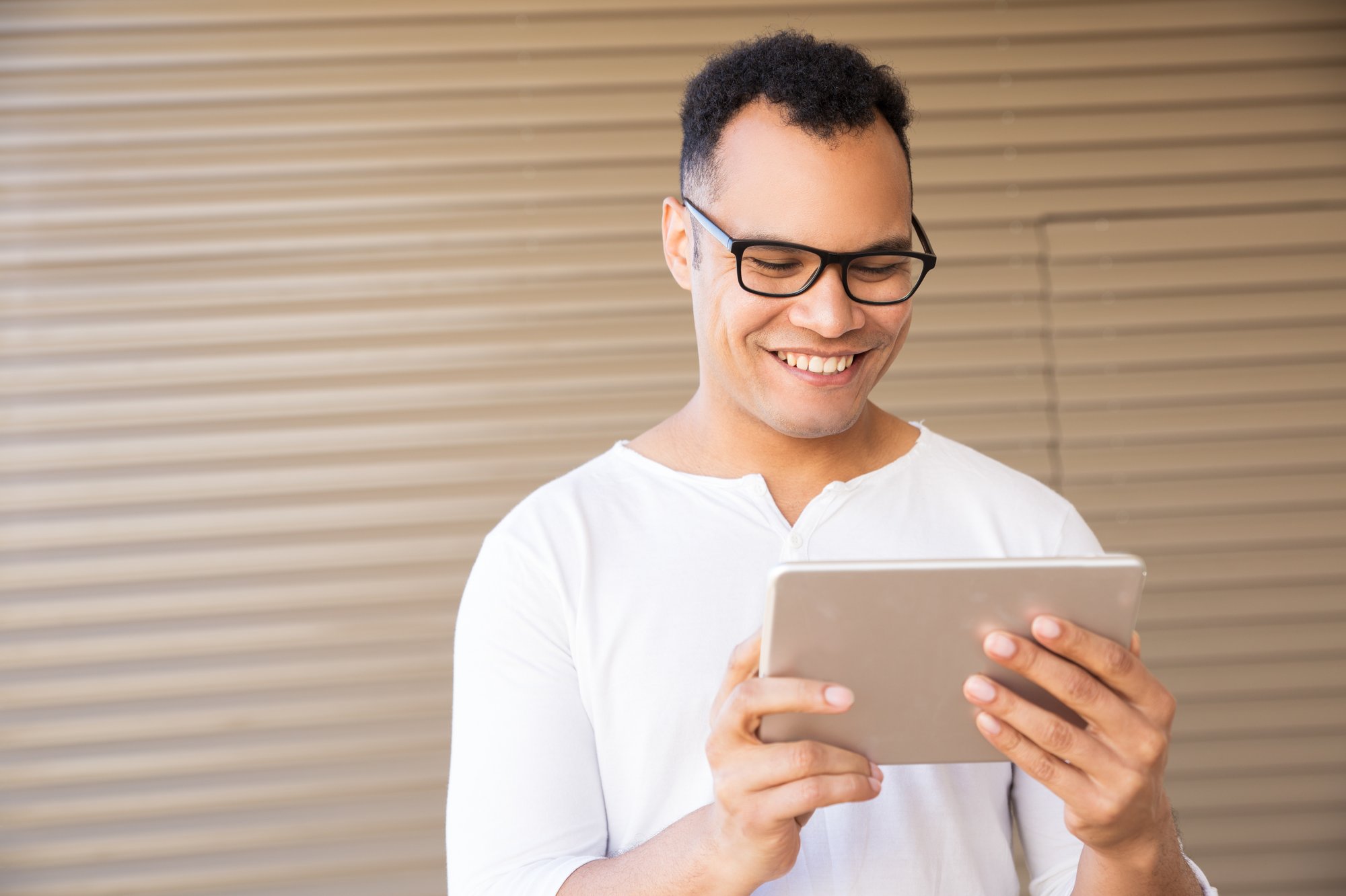 smiling-young-mixed-race-man-working-tablet-front-view